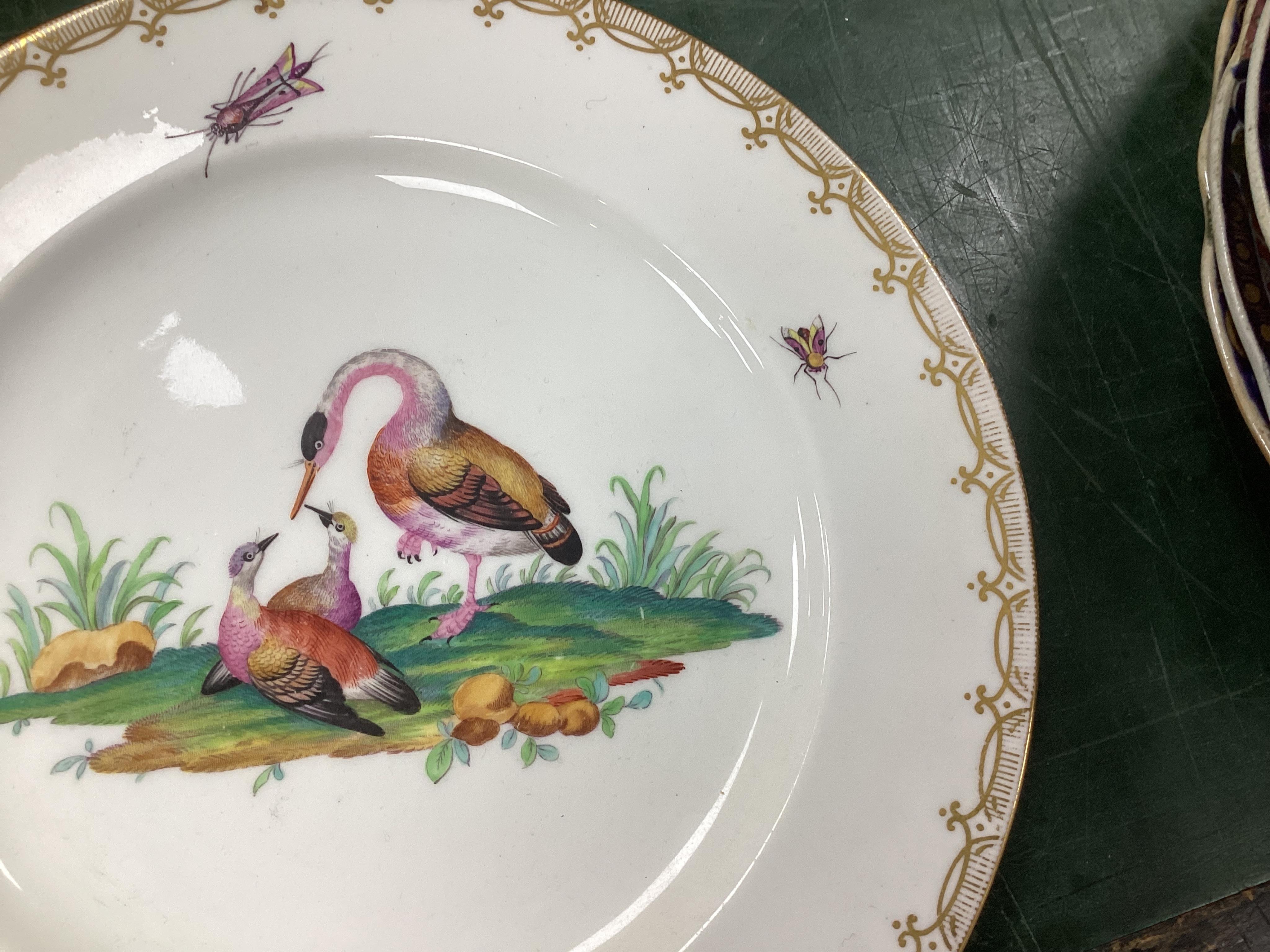 A Coalport bird painted part dinner service, mid 19th century